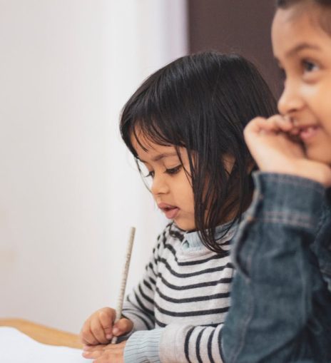 Two Girls Writing on Paper